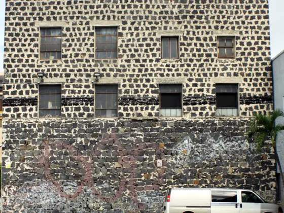 A white service van parked against a brick building
