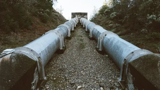 A large diameter pipeline running away between embankments