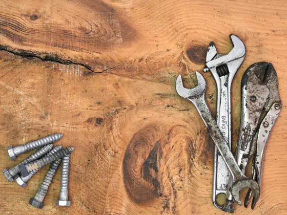 Adjustable wrenches and bolts on a workbench