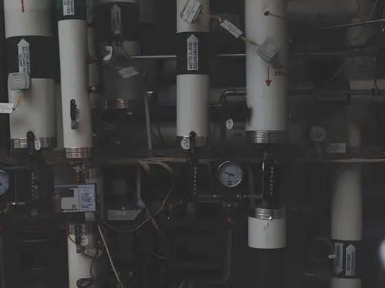 Pressure gauges and manifolds on a plant wall