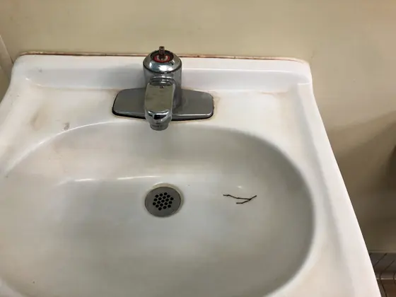 An old wall hung basin with the faucet removed