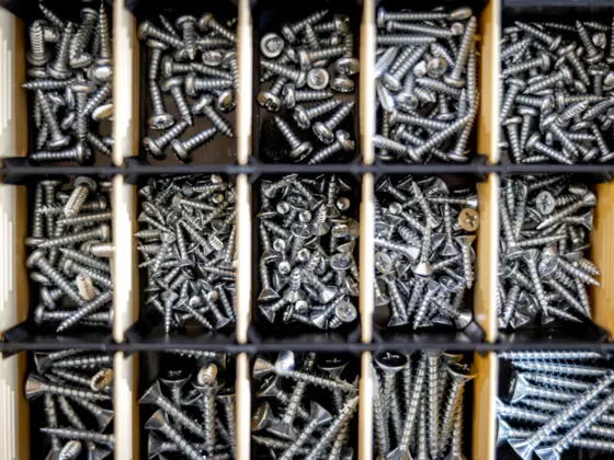 Sorted trays of fasteners and fittings in a parts drawer