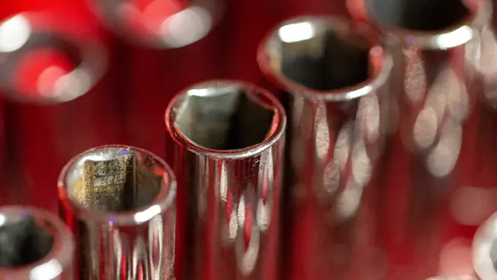 A set of chrome sockets in a red tray