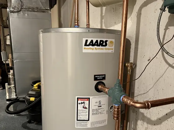 A newly installed gas water heater with copper flex connections